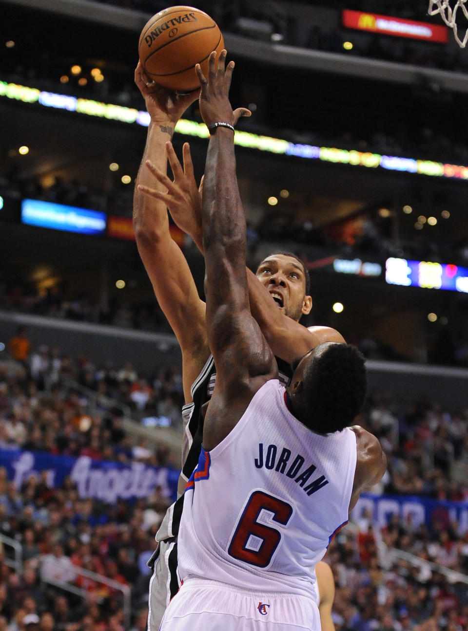 San Antonio Spurs forward Tim Duncan, back center, battles Los Angeles Clippers center DeAndre Jordan (6) as he makes a basket in the first half of a NBA basketball game, Tuesday, Feb. 18, 2014, in Los Angeles.(AP Photo/Gus Ruelas)