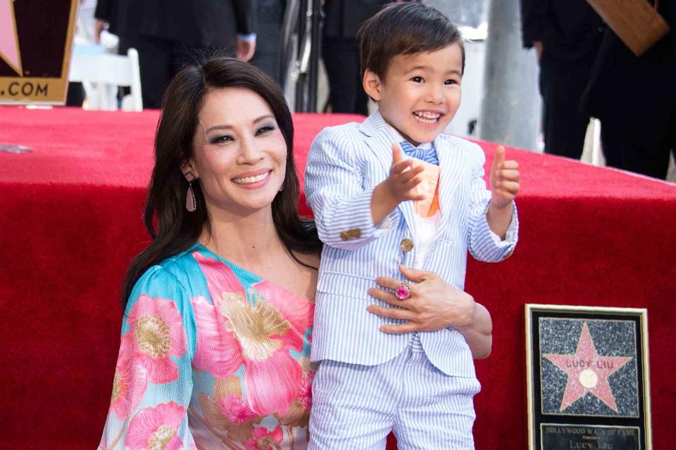 <p>VALERIE MACON/AFP/Getty</p> Lucy Liu is joined by her son Rockwell Lloyd as she receives her star on the Walk of Fame during a ceremony in Hollywood on May 1, 2019.