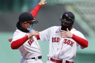 Boston Red Sox's Enrique Hernandez, left, and Alex Verdugo react during introductions before an opening day baseball game against the Baltimore Orioles, Friday, April 2, 2021, in Boston. (AP Photo/Michael Dwyer)