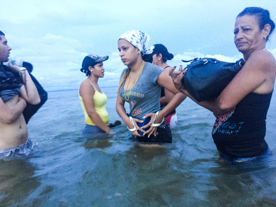 June 6, 2016 - Liset and Marta prepare to board a boat at dawn to go from Necocli to Capuragna in Colombia, getting closer to the Panamanian border. (Photo: Lisette Poole)