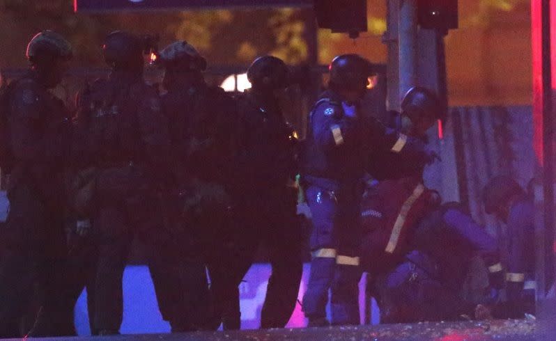 Paramedics tend to an unidentified person after the siege ended. Picture: AP