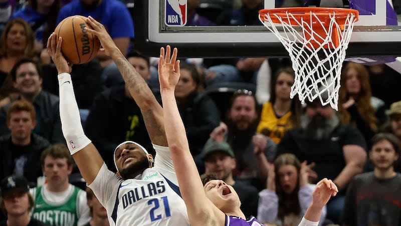 Dallas Mavericks center Daniel Gafford (21) grabs the rebound away from Utah Jazz center Walker Kessler (24) during an NBA game at the Delta Center in Salt Lake City on Monday, March 25, 2024.