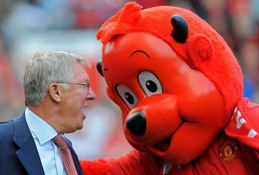 Manchester United manager Sir Alex Ferguson talks to club mascot Fred the Red at a game in 2011. The defining plot twist of the most enthralling title race in years could be written on Monday as City attempt to seize control of their Premier League destiny against leaders United