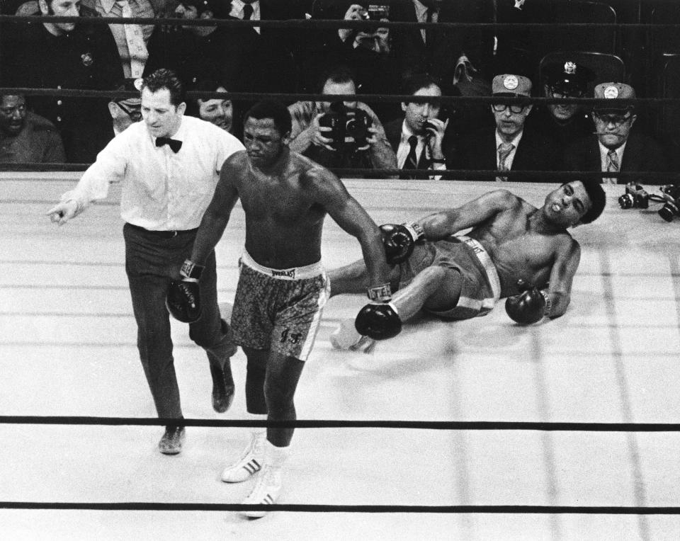 FILE - In this March 8, 1971, file photo, boxer Joe Frazier is directed to his corner by referee Arthur Marcante after knocking down Muhammad Ali during the 15th round of a title fight at Madison Square Garden in New York. Frazier won over Ali by decision. (AP Photo/File)