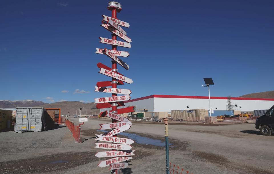 A directional sign for people with global ambition outside the Tesla Gigafactory in Nevada on Dec. 3, 2018.