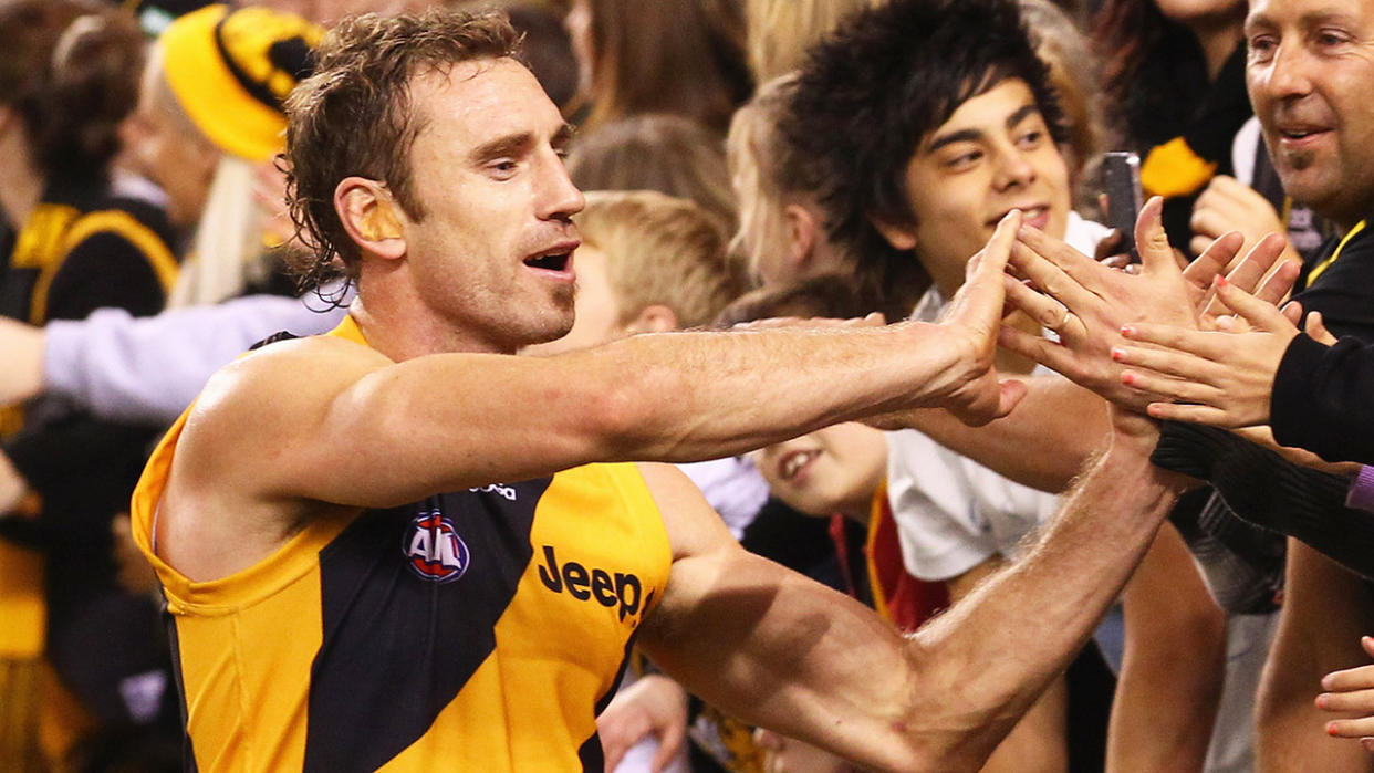 Shane Tuck is pictured celebrating with fans after a 2012 AFL victory.