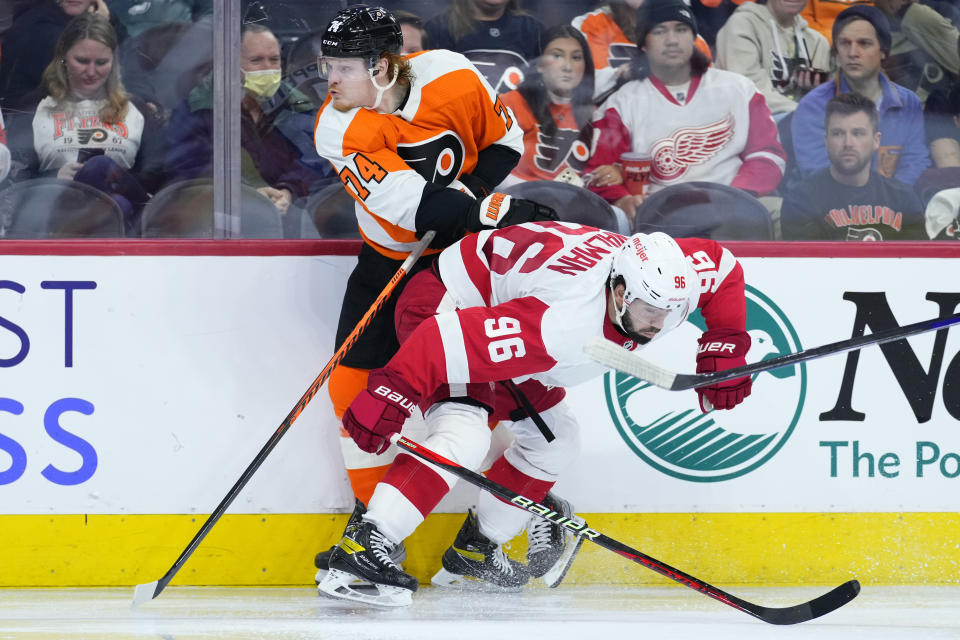 Philadelphia Flyers' Owen Tippett, left, tries to get past Detroit Red Wings' Jake Walman during the second period of an NHL hockey game, Sunday, March 5, 2023, in Philadelphia. (AP Photo/Matt Slocum)