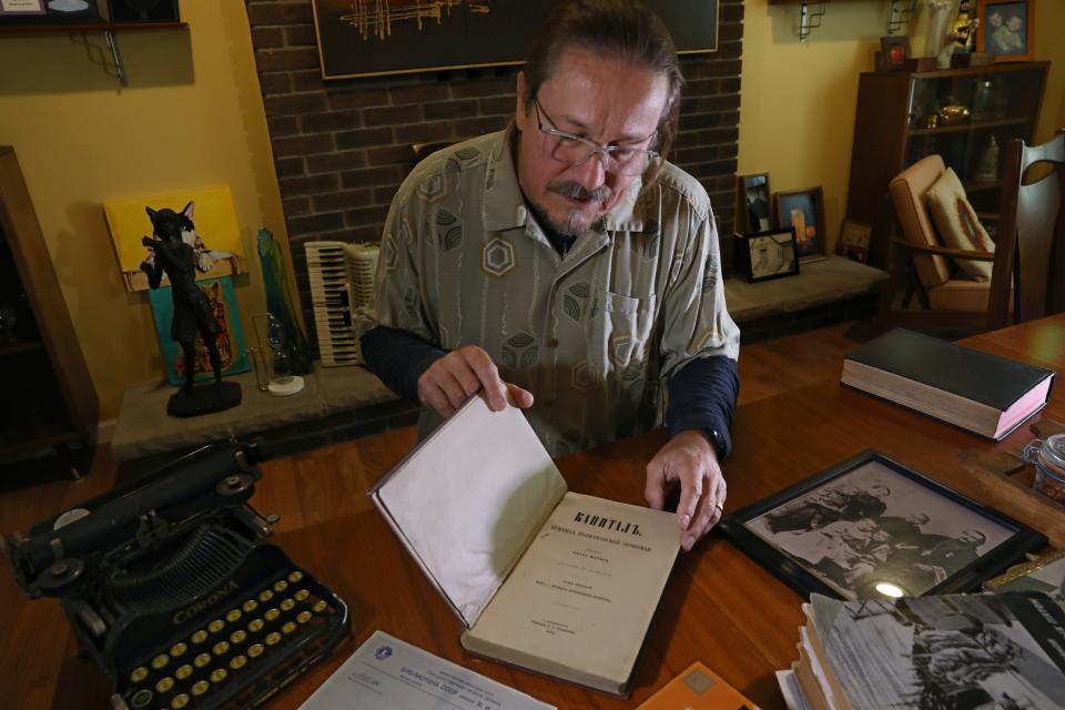 Nick Rozanov looks through a rare first edition of Karl Marx's Das Kapital, a book that was part of his father's collection. Rozanov keeps the book in a safe deposit box.