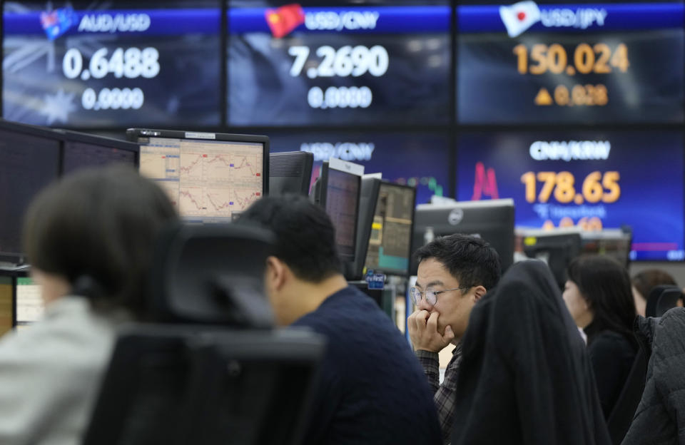 A currency trader watches monitors at the foreign exchange dealing room of the KEB Hana Bank headquarters in Seoul, South Korea, Tuesday, Nov. 7, 2023. Shares mostly fell in Asia on Tuesday after a mixed close on Wall Street, where wild recent moves calmed a bit at the beginning of a quiet week for data releases. (AP Photo/Ahn Young-joon)