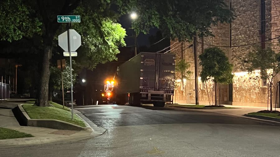 Damage to cars, street signs, etc. along East 9th Street near Embassy Drive after an 18-wheeler crashed into 10 parked vehicles overnight April 22, 2024 (KXAN Photo/Todd Bailey)