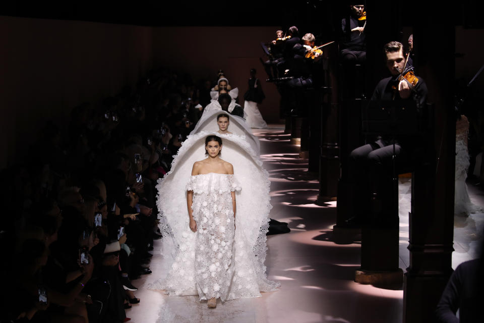 Model Kaia Gerber leads other models as they wear creations for the Givenchy Haute Couture Spring/Summer 2020 fashion collection presented Tuesday Jan. 21, 2020 in Paris. (AP Photo/Christophe Ena)