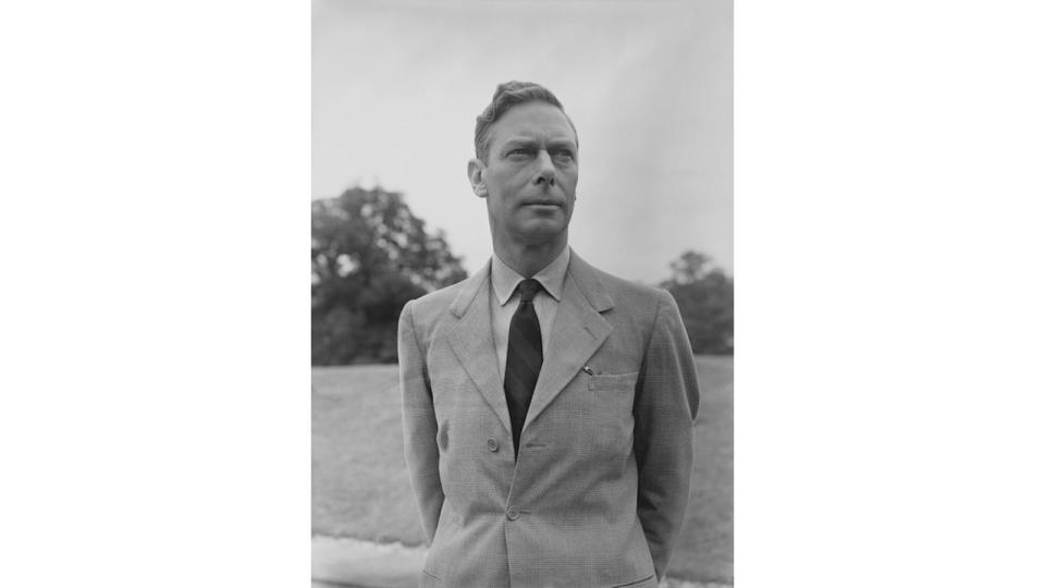Black and white photo of King George VI in a field
