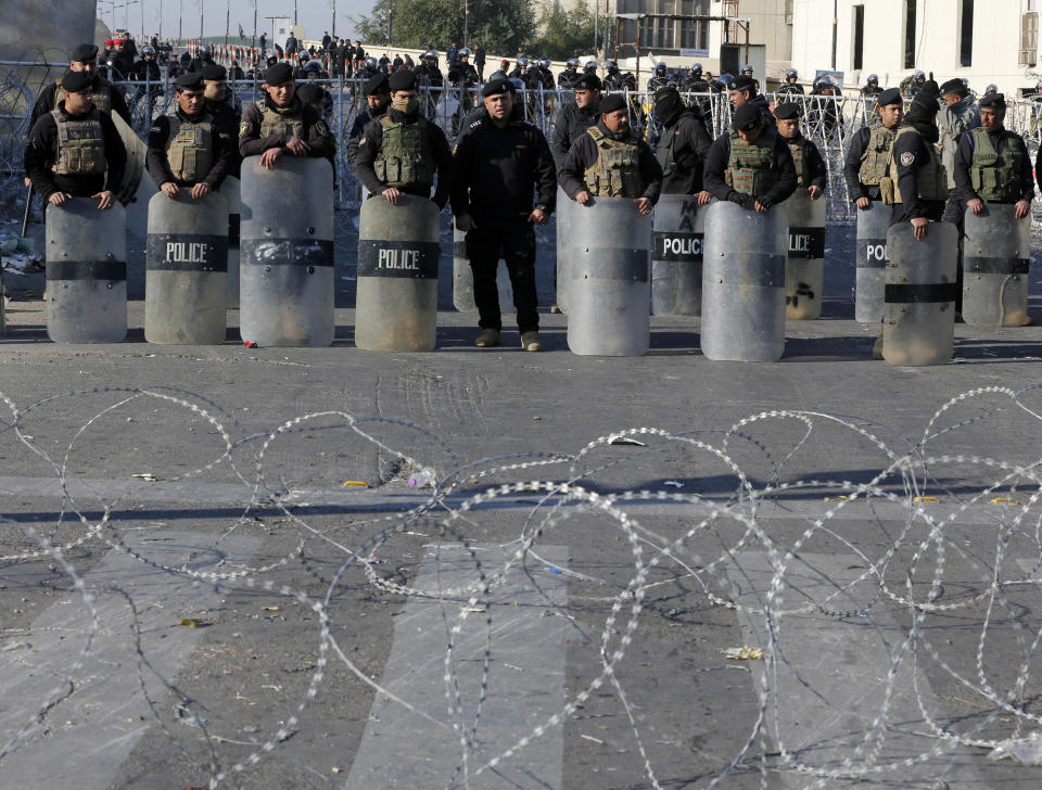 FILE - In this Feb. 11, 2017 file photo, Iraqi riot police close a bridge leading to the heavily guarded Green Zone during a demonstration of followers of Iraq's influential Shiite cleric Muqtada al-Sadr in Baghdad, Iraq. The 4-square mile (10-square kilometer), heavily guarded strip on the Tigris River was known as "Little America" following the 2003 U.S.-led invasion that toppled dictator Saddam Hussein. It then became a hated symbol of the country's inequality, fueling the perception among Iraqis that their government is out of touch. (AP Photo/Karim Kadim, File)