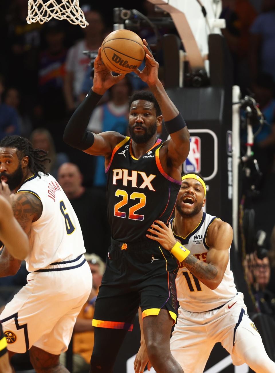 Phoenix Suns center Deandre Ayton (22) grabs a rebound against Denver Nuggets forward Bruce Brown (11) in the first half at Footprint Center, April 6, 2023.