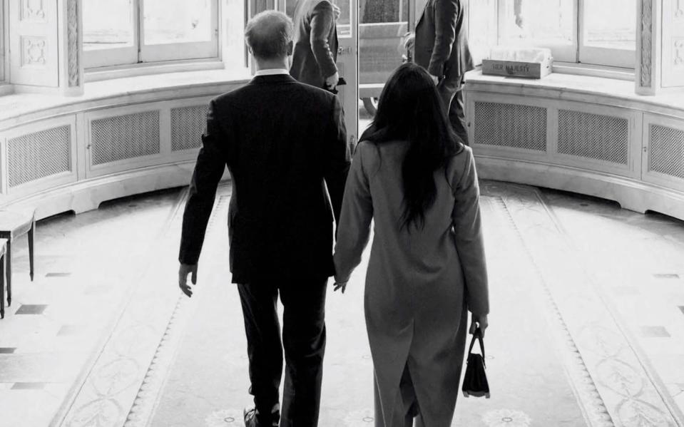 The professional, black and white image shows the couple with their backs to the camera, apparently walking out of the garden entrance - Netflix