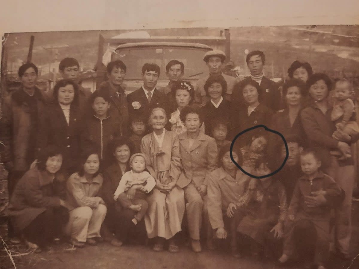 North Korean sisters Kim Cheol-ok (in circle) seen with her family, resting her hand on her sister Kim Kyu. Kyu is now searching for her sister Cheol-ok after reports of forcible deportation to North Korea by China  (Sourced/The Independent)