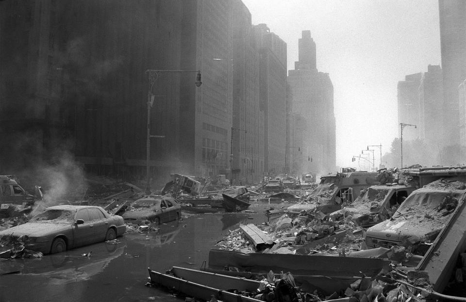 <p>West Street looking downtown is covered in rubble and damaged vehicles in the aftermath of the Sept. 11 attacks in 2001. (Photo: Shawn Baldwin/AP) </p>