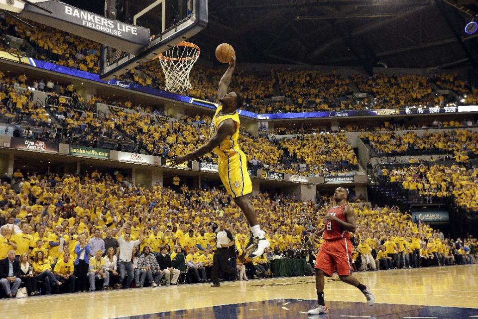 Indiana Pacers guard Lance Stephenson, left, goes up for a breakaway dunk in front of Atlanta Hawks guard Shelvin Mack (8) in the second half during Game 7 of a first-round NBA basketball playoff series in Indianapolis, Saturday, May 3, 2014. The Pacers won 92-80. (AP Photo/AJ Mast)