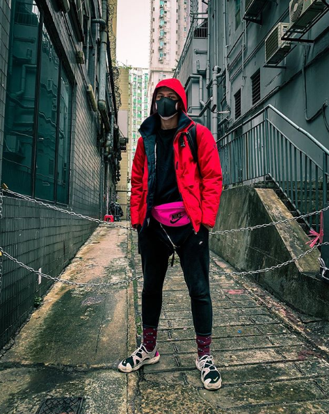 Steven Divish wearing a red hooded jacket and black face mask in China