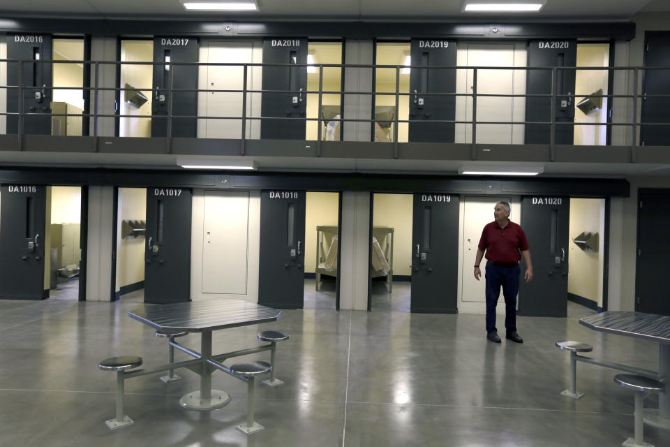 FILE - In this June 1, 2018, file photo, a man stands in a housing unit in the West section of the State Correctional Institution at Phoenix in Collegeville, Pa. Bill Cosby spent his first night of his three-to-10-year prison sentence for sexual assault alone in a single cell near the infirmary at the new state lock up outside Philadelphia. (AP Photo/Jacqueline Larma, File)