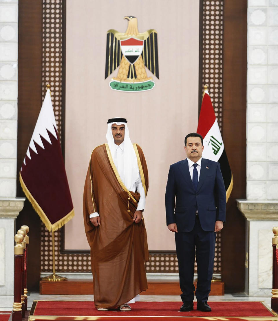 This photo from Iraqi Government, Iraqi Prime Minister Mohammed Shia al-Sudani, right, meets with Qatar's Emir Sheikh Tamim bin Hamad al-Thani, in Baghdad, Iraq, Thursday, June 15, 2023. The two countries signed a broad agreement to expand "cooperation in politics, economics, energy, and investment," Sudani said in a statement. (Iraqi Prime Minister Media Office via AP)