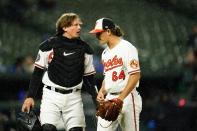 Baltimore Orioles catcher Adley Rutschman, left, talks with starting pitcher Dean Kremer after pitching to the Toronto Blue Jays during the fourth inning of a baseball game, Monday, Oct. 3, 2022, in Baltimore. (AP Photo/Julio Cortez)