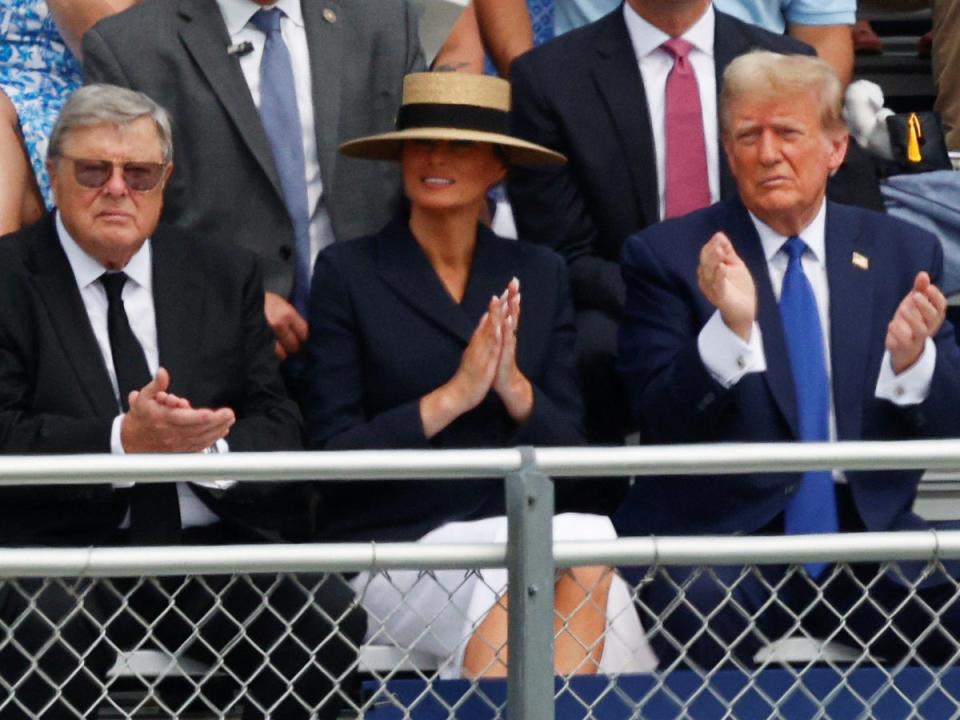 Melania Trump, sat with her father Viktor Knavs and husband Donald Trump, at her son Barron Trump’s high school graduation ceremony at Oxbridge Academy in West Palm Beach, Florida, on 17 May 2024 (Marco Bello/Reuters)