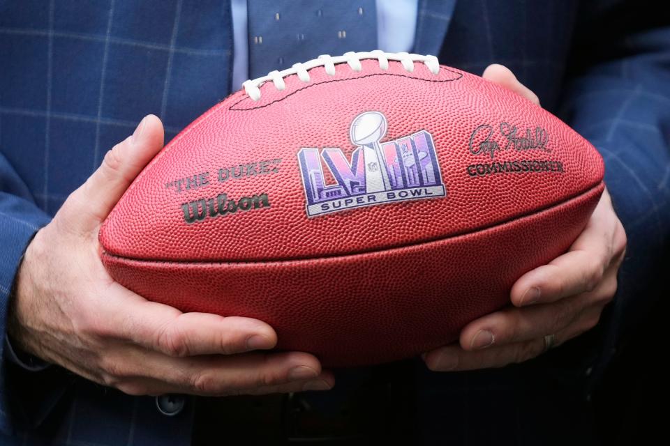 Nevada Republican Gov. Joe Lombardo holds an NFL football with the Super Bowl LVIII logo on it after the Arizona Super Bowl Host Committee handed off the ball to the Las Vegas Super Bowl Host Committee for Super Bowl LVIII during an NFL Super Bowl football game news conference in Phoenix, Monday, Feb. 13, 2023. (AP Photo/Ross D. Franklin)