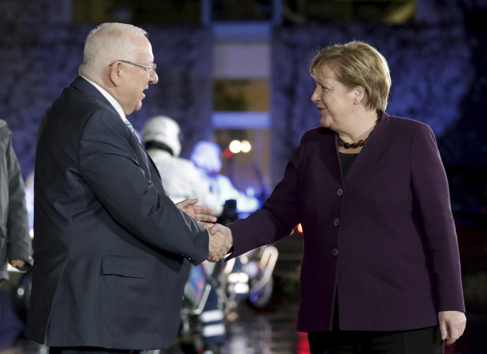 German Chancellor Angela Merkel, right, welcomes Israel's President Reuven Rivlin, for a meeting at the Chancellery in Berlin, Germany, Tuesday, Jan. 28, 2020. (AP Photo/Michael Sohn)