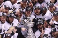 Pittsburgh Penguins center Sidney Crosby (C) and his teammates pose for a team photo with the Stanley Cup after defeating the San Jose Sharks in game six of the 2016 Stanley Cup Final at SAP Center at San Jose. Gary A. Vasquez-USA TODAY Sports - RTX2FV3W