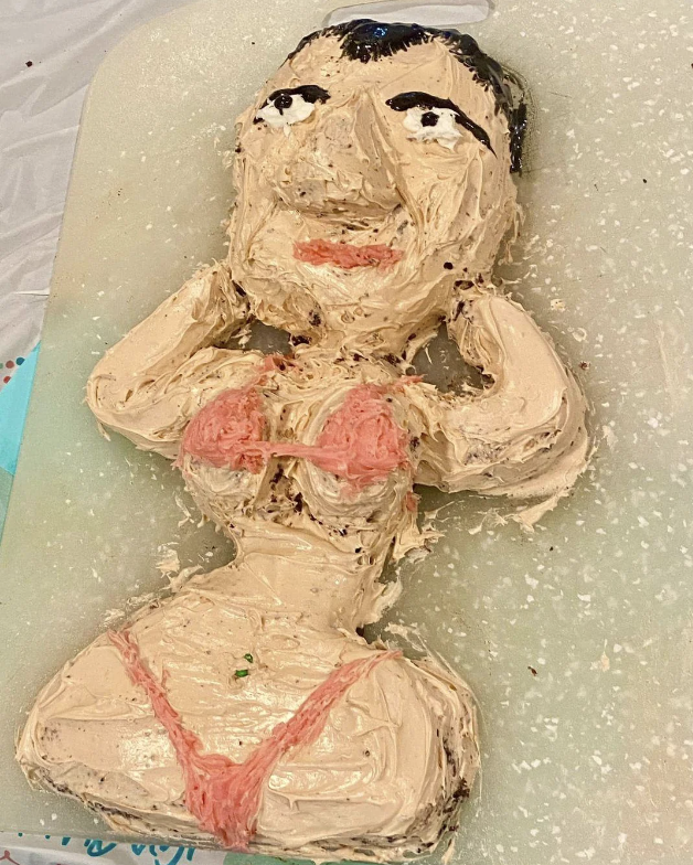 Cake in the shape of a person with a detailed face and body, wearing a bikini