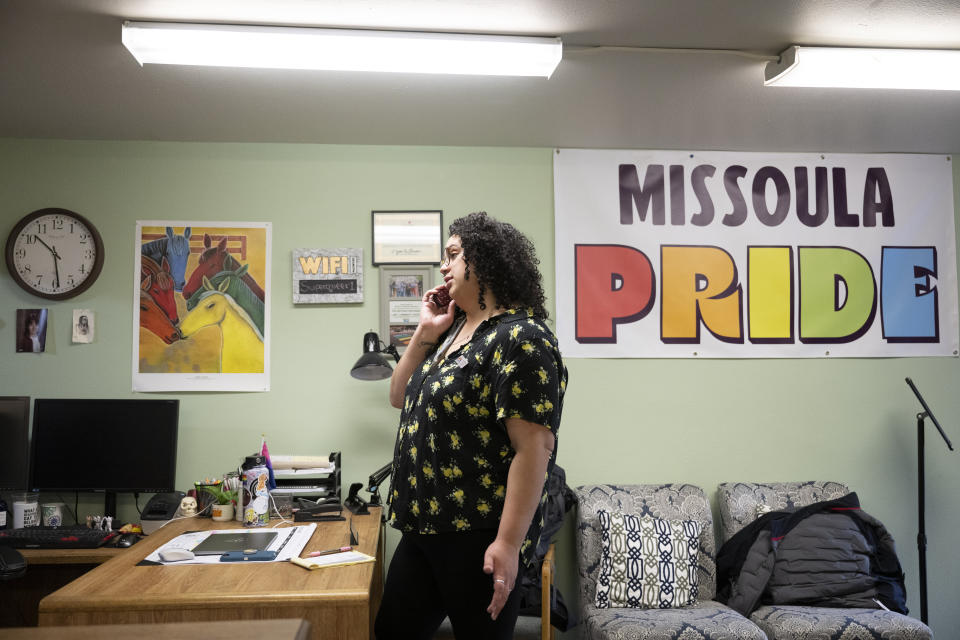Kera Rivera, operations administrator, answers the phone at The Center in Missoula, Mont., Tuesday, April, 25, 2023. The nonprofit provides space, resources and support to lesbian, gay, bisexual, transgender, intersex and non-binary people in Missoula. (AP Photo/Tommy Martino)