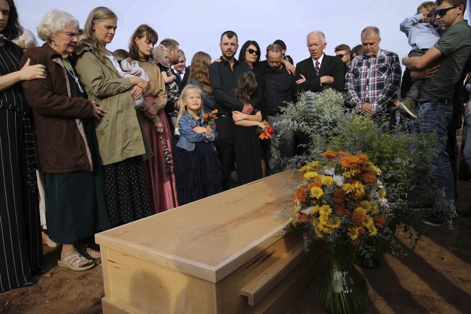 Family and friends attend the burial service of Christina Langford Johnson the last victim of a cartel ambush that killed nine American women and children earlier this week, in Colonia LeBaron, Mexico, Saturday, Nov. 9, 2019. In the attack Monday, Langford Johnson jumped out of her vehicle and waved her hands to show she was no threat to the attackers and was shot twice in the heart, community members say. Her daughter Faith Marie Johnson, 7 months old, was found unharmed in her car seat. (AP Photo/Marco Ugarte)