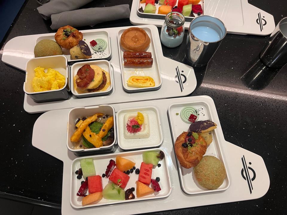 breakfast trays with egg, fruit, and other small plates on galactic starcruiser