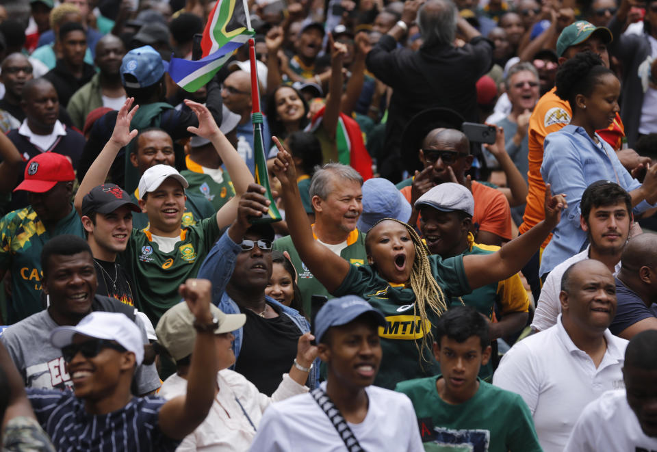 South Africa fans watching a giant screen at the Nelson Mandela Square in Johannesburg, South Africa, celebrate South Africa scoring points during the Rugby World Cup final between South Africa and England being played in Tokyo, Japan on Saturday Nov. 2, 2019. South Africa defeated England 32-12. (AP Photo/Denis Farrell)