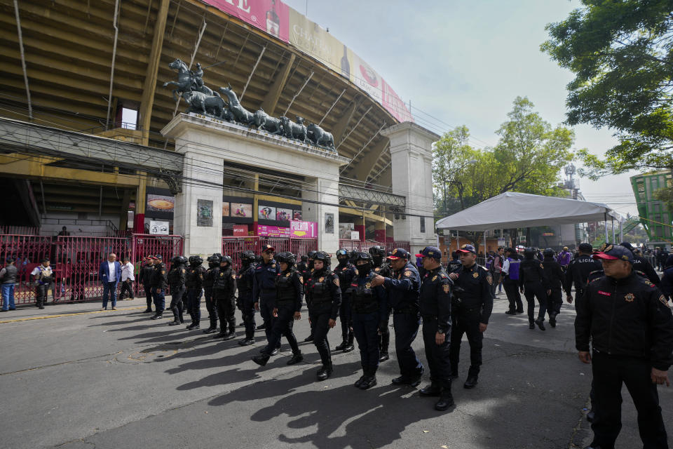 Police agents stand guard at the Plaza Mexico before a bullfighting in Mexico City, Sunday, Jan. 28, 2024. Bullfighting returns to Mexico City after the Supreme Court of Justice overturned a 2022 ban that prevented these events from taking place in the capital. (AP Photo/Fernando Llano)