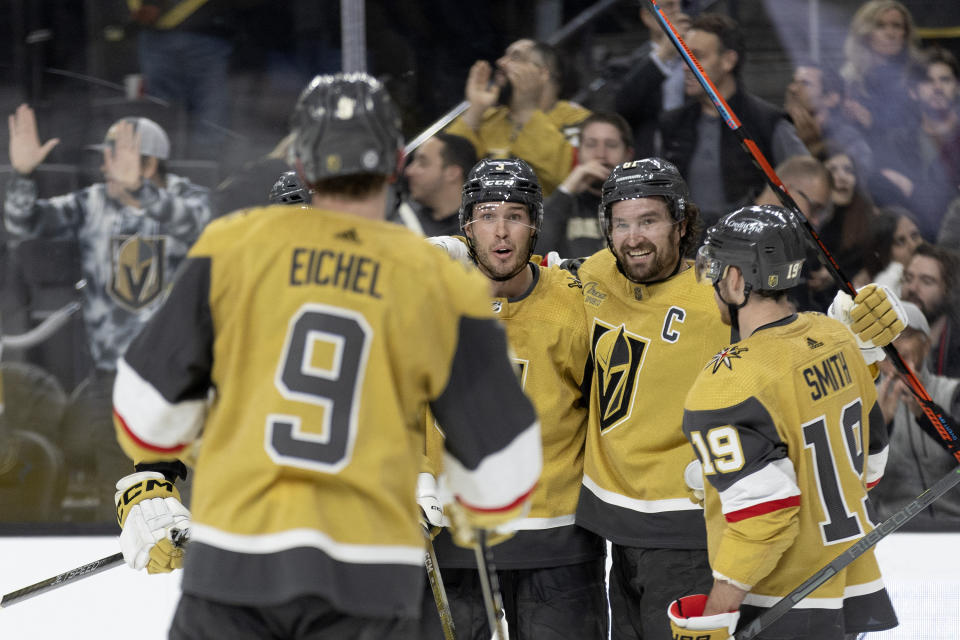 Vegas Golden Knights right wing Mark Stone, second from right, celebrates his goal with center Jack Eichel (9), defenseman Brayden McNabb, second from left, and right wing Reilly Smith during the second period of the team's NHL hockey game against the Pittsburgh Penguins on Thursday, Jan. 5, 2023, in Las Vegas. (AP Photo/Ellen Schmidt)