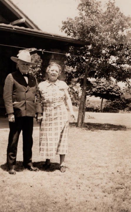 Pawnee Bill and his wife in front of their mansion, 1936.