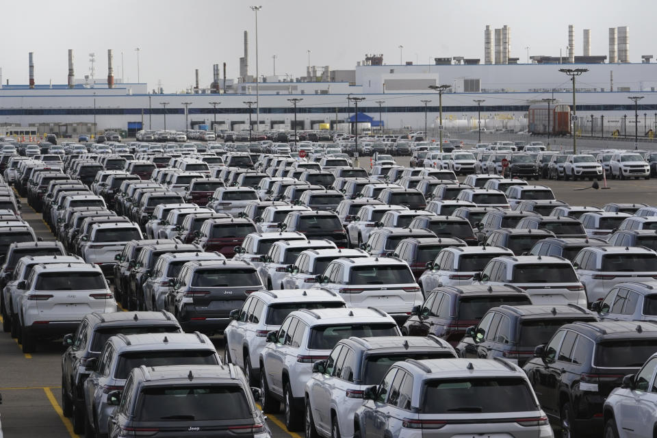 New vehicles are shown parked in storage lots near the the Stellantis Detroit Assembly Complex in Detroit, Wednesday, Oct. 5, 2022. Over the past few years, thieves have driven new vehicles from automaker storage lots and dealerships across the Detroit area. In 2018, eight vehicles were driven from what then was Fiat Chrysler's Jefferson North plant. (AP Photo/Paul Sancya)