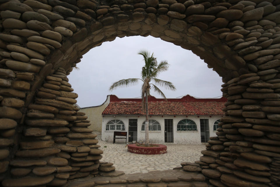 A former cell block is framed by a stone monument in Puerto Balleto, during a media tour of the now closed Islas Marias penal colony located off Mexico's Pacific coast, Saturday, March 16, 2019. Islas Marias was founded in 1905 on the idea that penal colonies could earn their keep and reform inmates through clean living, ocean air and hard work. (AP Photo/Rebecca Blackwell)