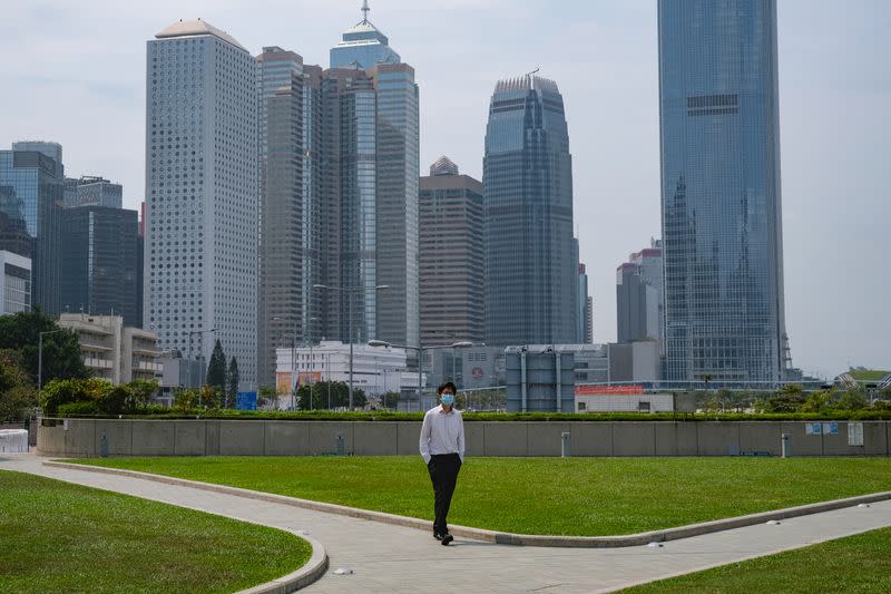 A man with a protective face mask takes his lunch breaks at the financial Central district, following the coronavirus disease (COVID-19) outbreak, in Hong Kong