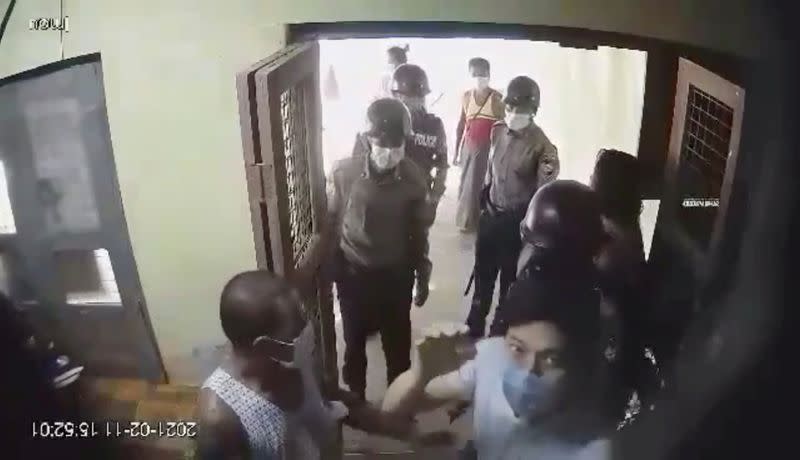 Dr Pyae Phyo Naing (in face mask, lower right) is seen as he is detained by police at his clinic in the Irrawaddy delta region