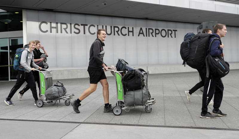 Tourists arrive at the Christchurch Airport terminal as they prepare to check in for a charter flight back to Germany via Vancouver from Christchurch, New Zealand.