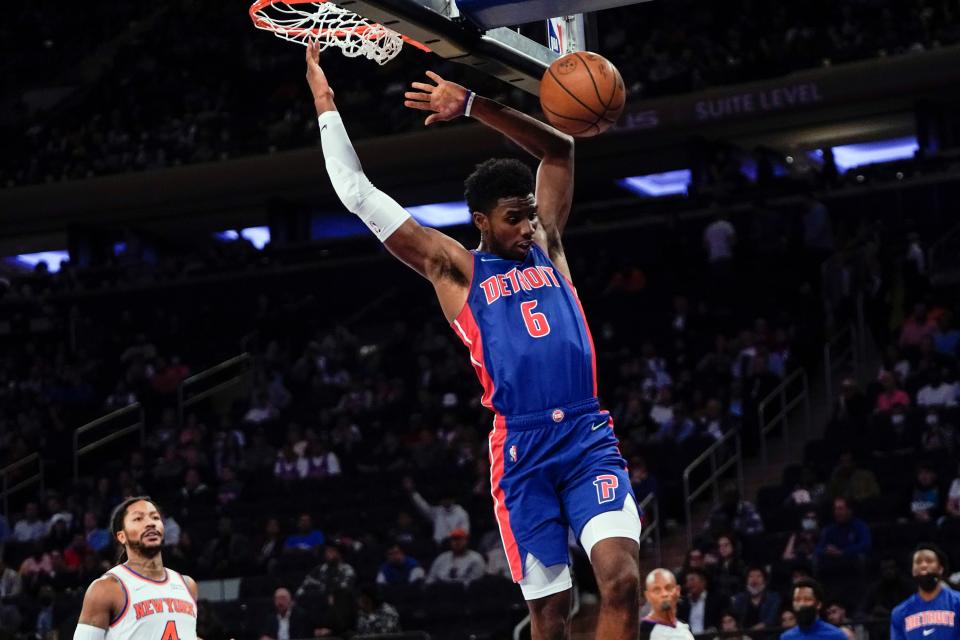 Detroit Pistons' Hamidou Diallo dunks in front of New York Knicks' Derrick Rose during the first half of a preseason NBA basketball game Wednesday, Oct. 13, 2021, in New York.