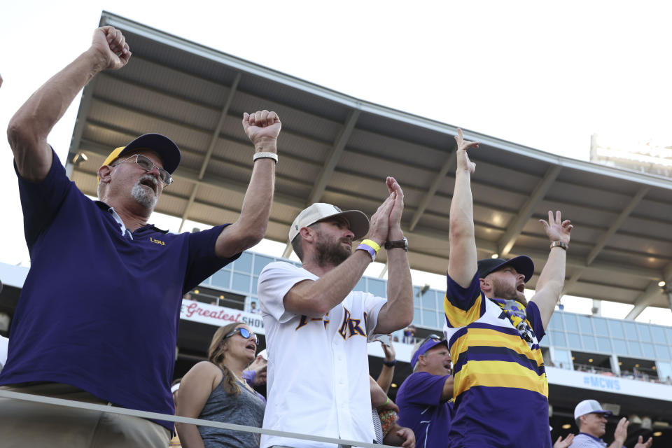 LSU fans Jimmy St. Pierre, left, T.J. Fontenot, and Wes St. Pierre, right, all from Gonzales, La., cheer during Game 3 of the NCAA College World Series baseball finals against Florida in Omaha, Neb., Monday, June 26, 2023. (AP Photo/Rebecca S. Gratz)