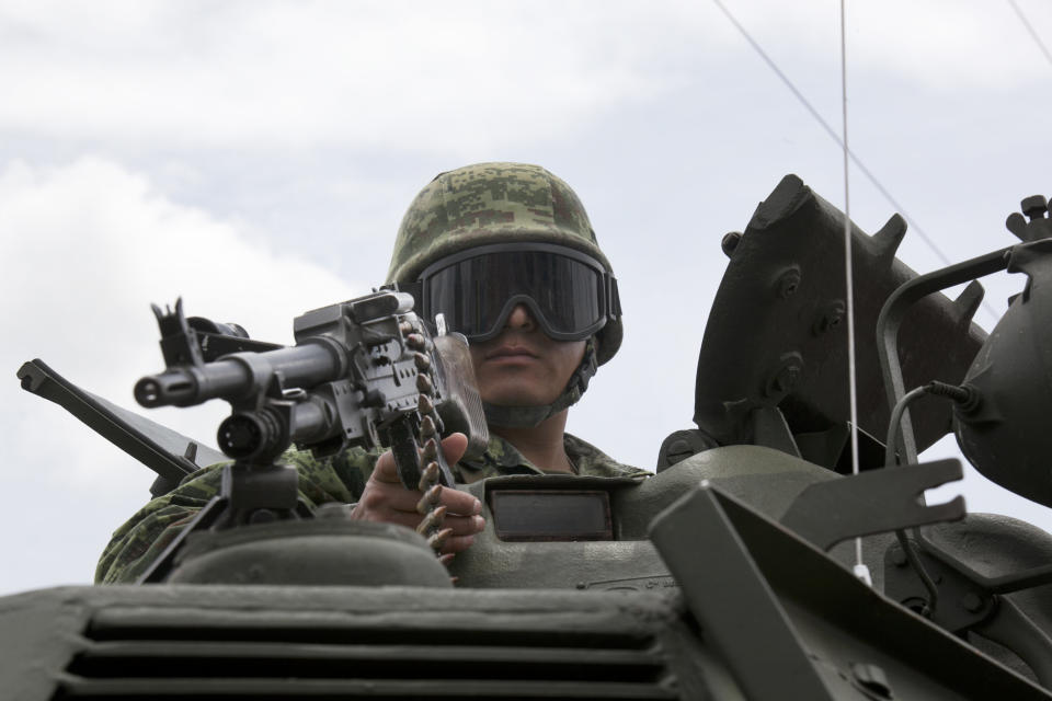 A soldier stands on an armored vehicle as he guards near the Altiplano maximum security prison in Almoloya, west of Mexico City, Sunday, July 12, 2015. (AP Photo/Marco Ugarte)
