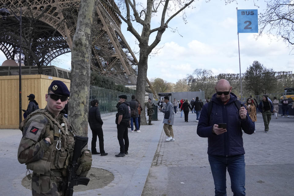 A soldier patrols at the Eiffel Tower, Monday, March 25, 2024 in Paris. France's government increased its security alert posture to the highest level Sunday March 24, 2024 after the deadly attack at a Russian concert hall and the Islamic State's claim of responsibility. (AP Photo/Michel Euler)