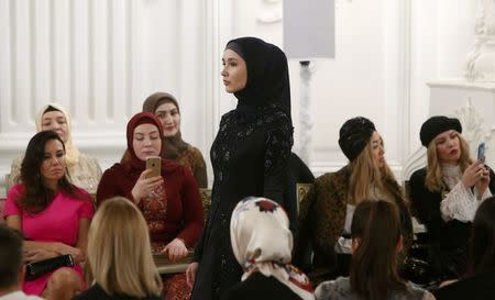 A model presents a creation during a show of the Firdaws fashion house led by Aishat Kadyrova, daughter of the Chechen Republic head Ramzan Kadyrov, at the Mercedes-Benz Fashion Week Russia in Moscow, Russia, March 17, 2017. REUTERS/Sergei Karpukhin