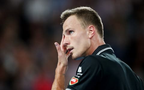 Hungary's Marton Fucsovics reacts during his match against Switzerland's Roger Federer