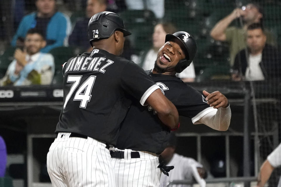 Chicago White Sox's Eloy Jimenez (74) celebrates his three-run home run off Colorado Rockies starting pitcher Chad Kuhl with Elvis Andrus during the first inning of a baseball game Tuesday, Sept. 13, 2022, in Chicago. (AP Photo/Charles Rex Arbogast)